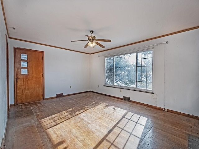 unfurnished room with ceiling fan, ornamental molding, and dark hardwood / wood-style floors