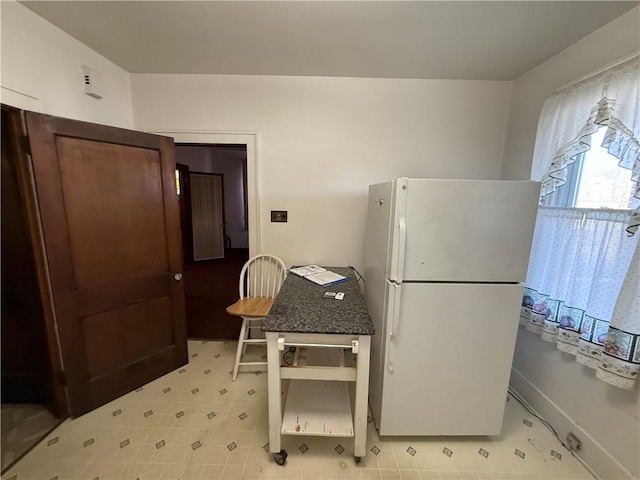 kitchen featuring white fridge