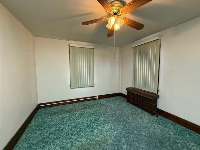 spare room featuring carpet flooring and ceiling fan