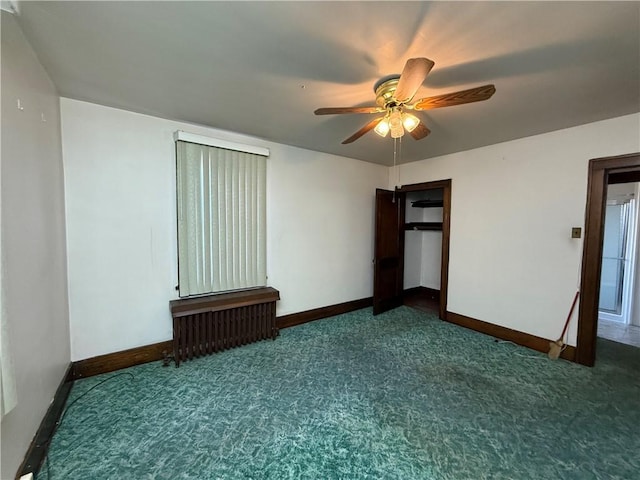 unfurnished bedroom with dark carpet and ceiling fan