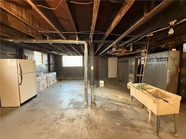 basement featuring white fridge