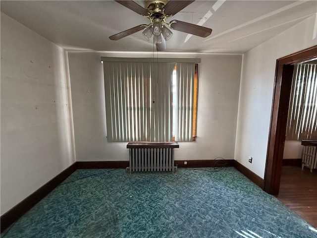 carpeted empty room with radiator heating unit