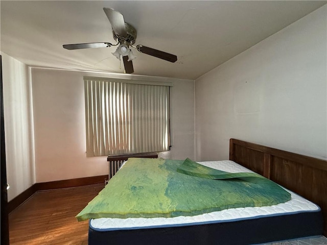 bedroom with wood-type flooring and ceiling fan