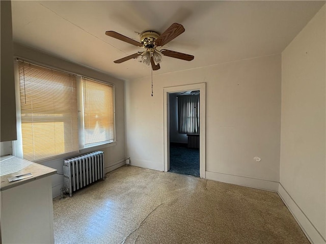 empty room with radiator and ceiling fan