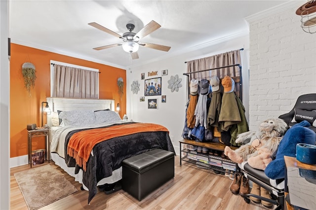 bedroom with hardwood / wood-style flooring, ceiling fan, and ornamental molding