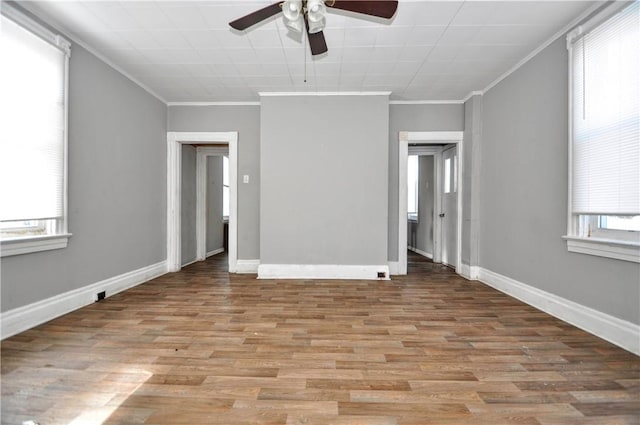 unfurnished room featuring crown molding, light hardwood / wood-style floors, and ceiling fan