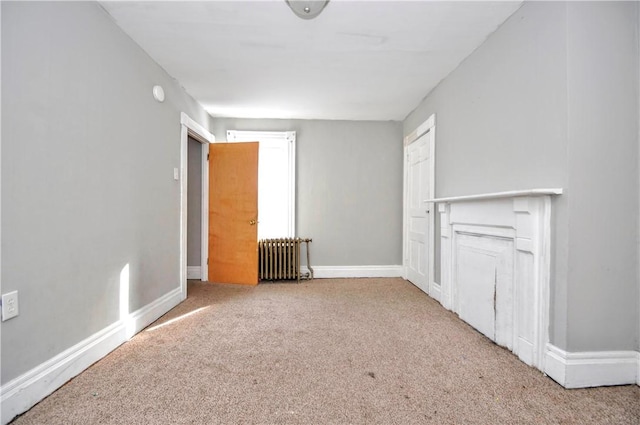 unfurnished room with light carpet and radiator