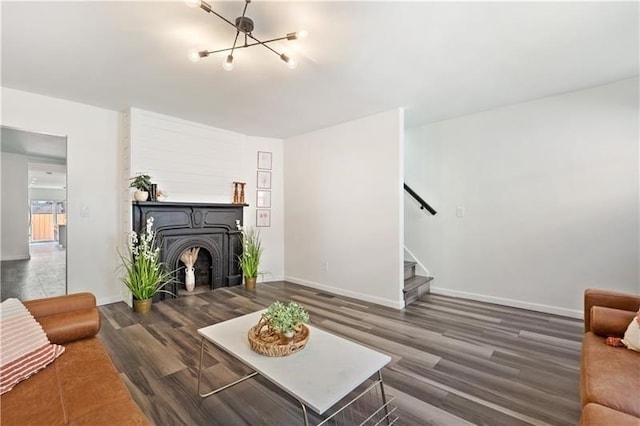 living room with dark hardwood / wood-style floors and a notable chandelier