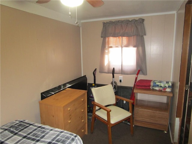 bedroom featuring ceiling fan, ornamental molding, and dark carpet