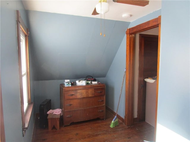 bedroom with dark wood-type flooring, ceiling fan, and vaulted ceiling