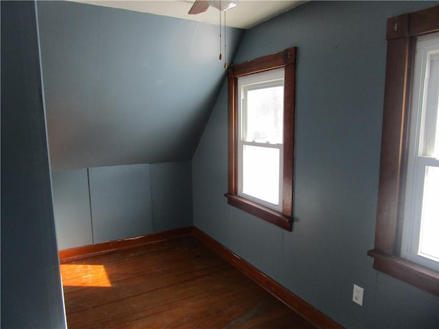 additional living space featuring lofted ceiling, dark wood-type flooring, and ceiling fan