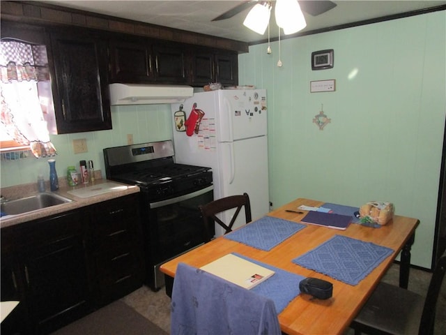 kitchen with white refrigerator, sink, stainless steel range with gas stovetop, and ceiling fan