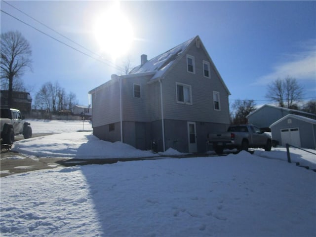 view of snow covered back of property