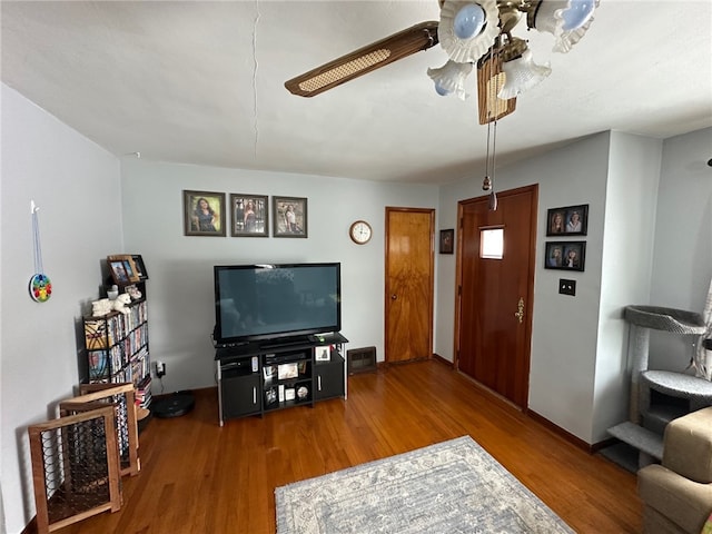 living room with hardwood / wood-style floors and ceiling fan