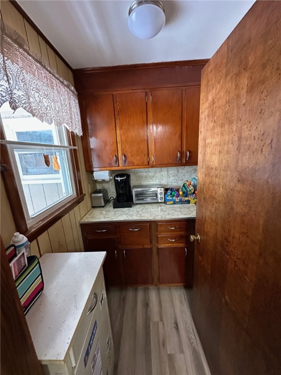 kitchen featuring tasteful backsplash and wood-type flooring