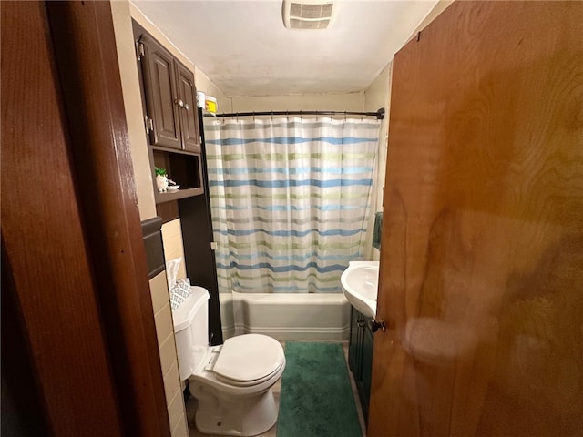 full bathroom featuring toilet, vanity, and shower / bath combo with shower curtain