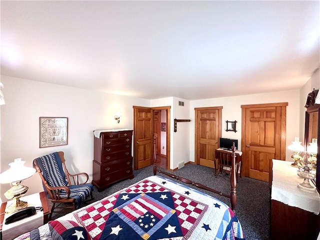 bedroom with dark colored carpet