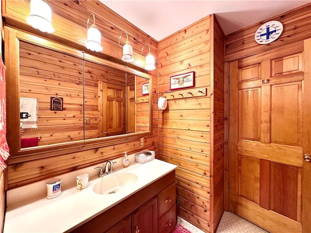 bathroom featuring vanity and wood walls