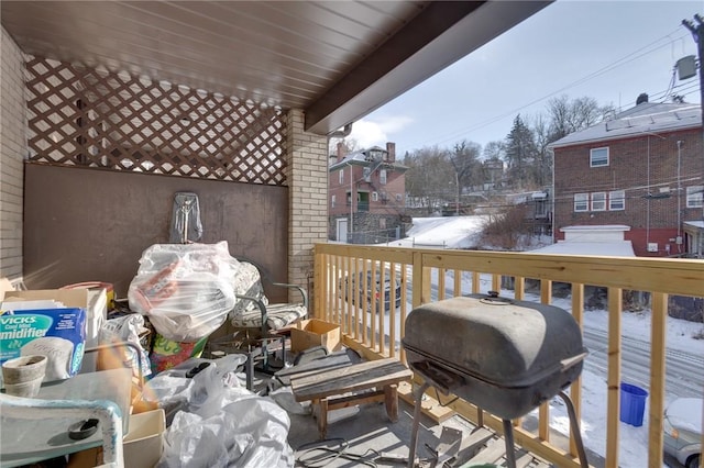 snow covered back of property featuring a grill