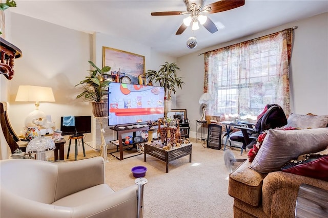 carpeted living room with ceiling fan