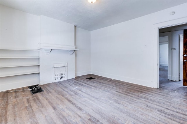 unfurnished living room featuring hardwood / wood-style floors