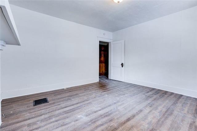 empty room featuring wood-type flooring