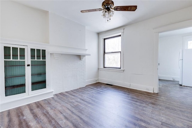 unfurnished living room featuring ceiling fan and hardwood / wood-style floors