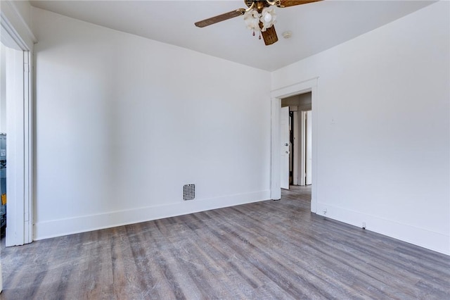 spare room featuring dark hardwood / wood-style flooring and ceiling fan