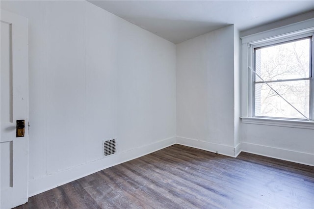 spare room with dark hardwood / wood-style floors