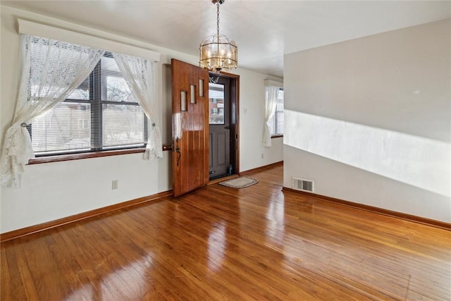 entrance foyer featuring a notable chandelier and hardwood / wood-style flooring