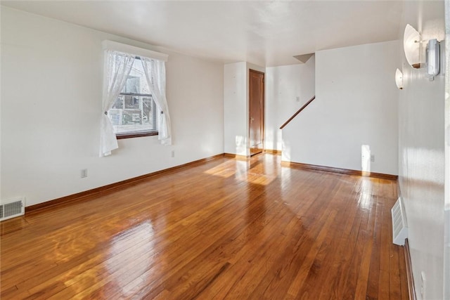 unfurnished living room with wood-type flooring