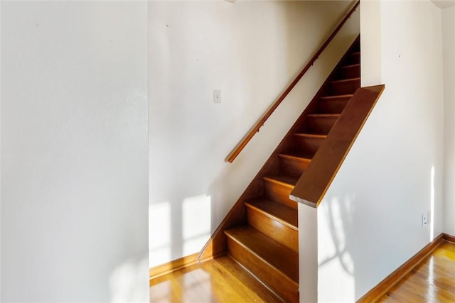 stairs with hardwood / wood-style flooring