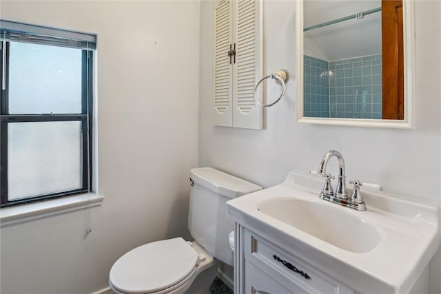 bathroom with a healthy amount of sunlight, sink, and toilet