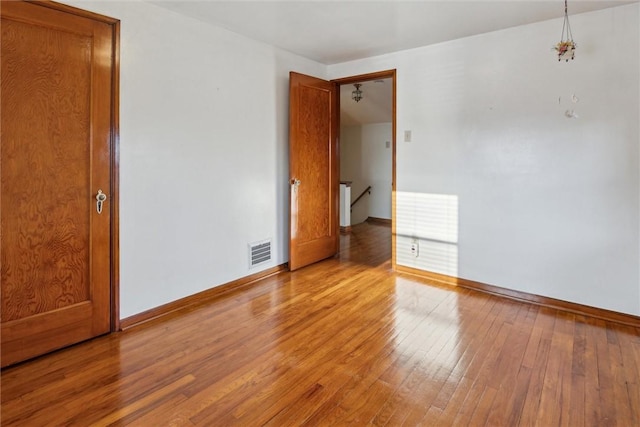 spare room with light wood-type flooring