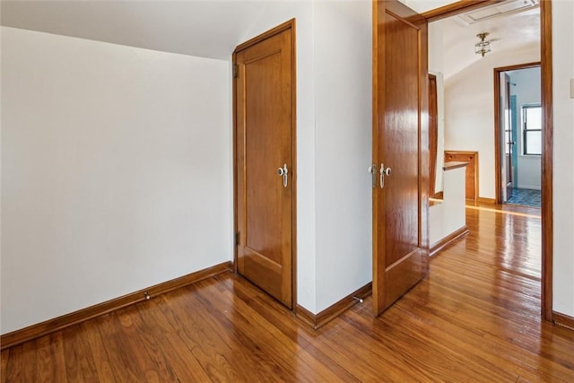 interior space featuring lofted ceiling and hardwood / wood-style floors