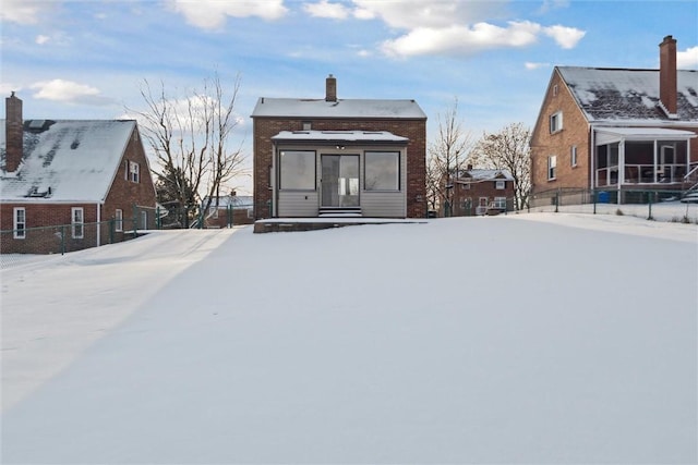 view of snow covered rear of property