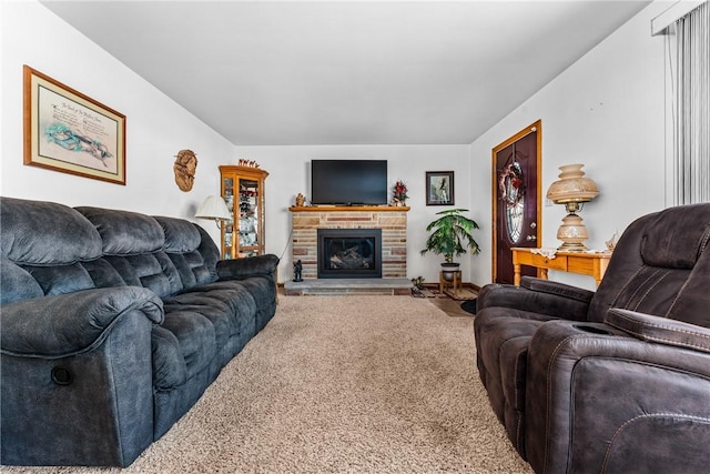 carpeted living room featuring a stone fireplace