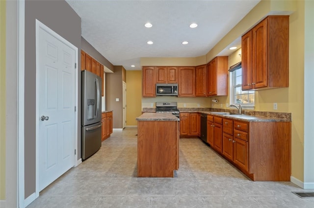 kitchen featuring a kitchen island, sink, and appliances with stainless steel finishes