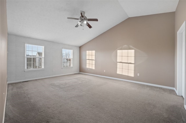 carpeted empty room with vaulted ceiling and ceiling fan