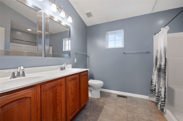 bathroom featuring vanity, toilet, and walk in shower