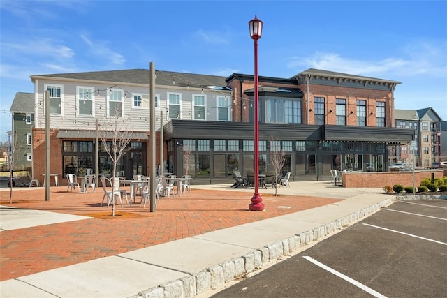 view of building exterior with uncovered parking