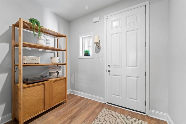 entrance foyer with light wood-type flooring and baseboards