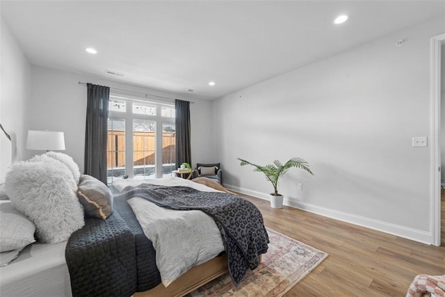 bedroom with light wood-type flooring, visible vents, baseboards, and recessed lighting