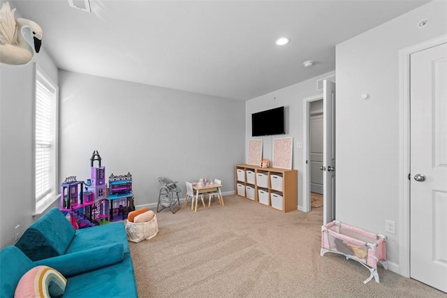 recreation room with recessed lighting, light colored carpet, and baseboards