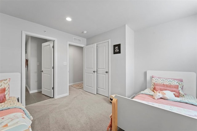 bedroom with light carpet, recessed lighting, visible vents, and baseboards