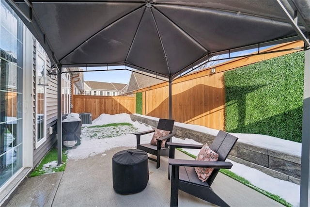 view of patio with a gazebo, cooling unit, and a fenced backyard