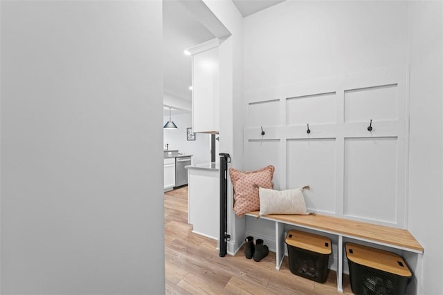 mudroom with a decorative wall and light wood-style floors