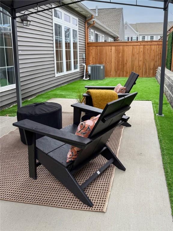 view of patio / terrace with fence and cooling unit