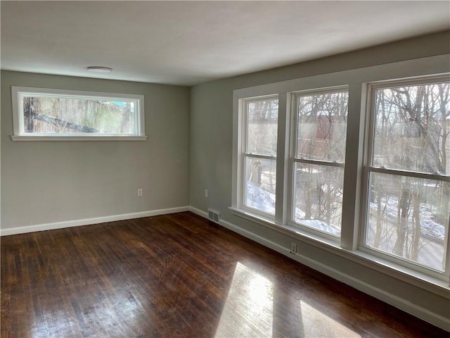 unfurnished room featuring dark hardwood / wood-style floors