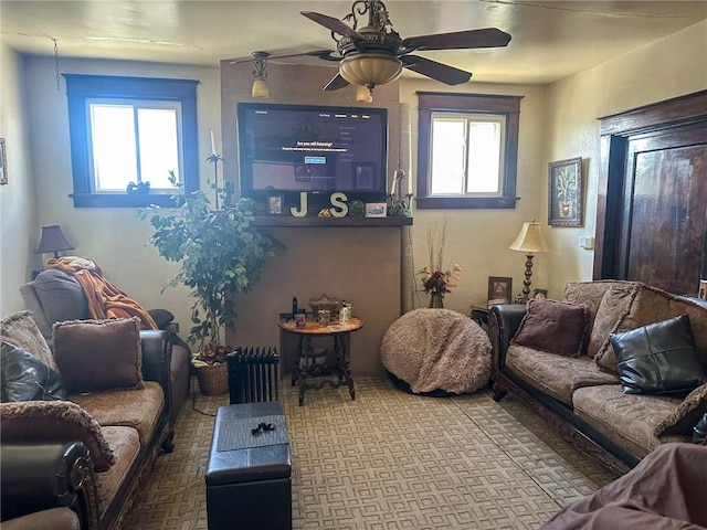 carpeted living room featuring a wealth of natural light and ceiling fan